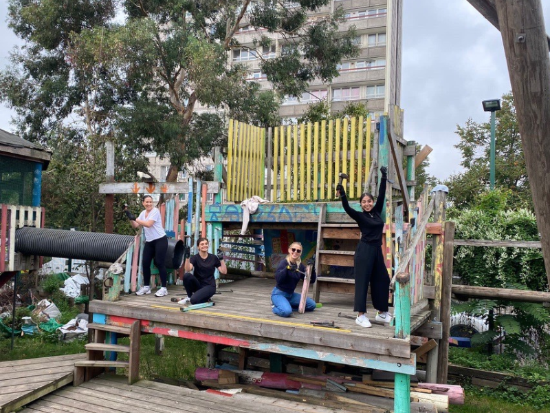 A group of UpSlide employees building a playground as part of a volunteering day.