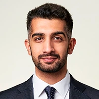 Professional headshot of a man in a suit and tie.