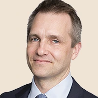 Professional headshot of a man in a suit and tie.
