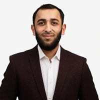 Professional man with beard in suit and white shirt smiling