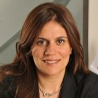 Professional woman with brown hair smiling confidently