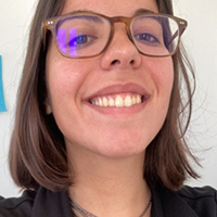 Smiling woman with glasses looking at the camera.