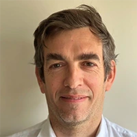 Man presenting project management software interface on laptop