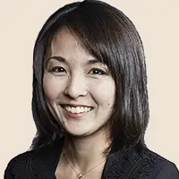 Professional Asian woman smiling in a business setting.