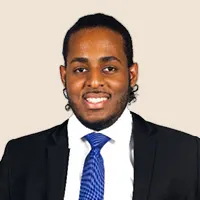 Professional headshot of a smiling man in a suit and blue tie.