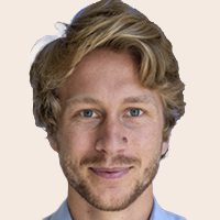 Portrait of a man with blond hair and blue eyes smiling.