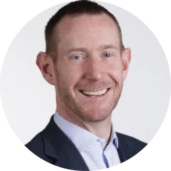 Man smiling, likely discussing investment banking software report trends.