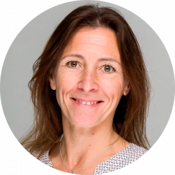 Professional woman smiling, possibly involved in financial services rebrand.