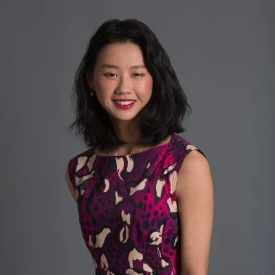 Portrait of a smiling Asian woman wearing a purple dress